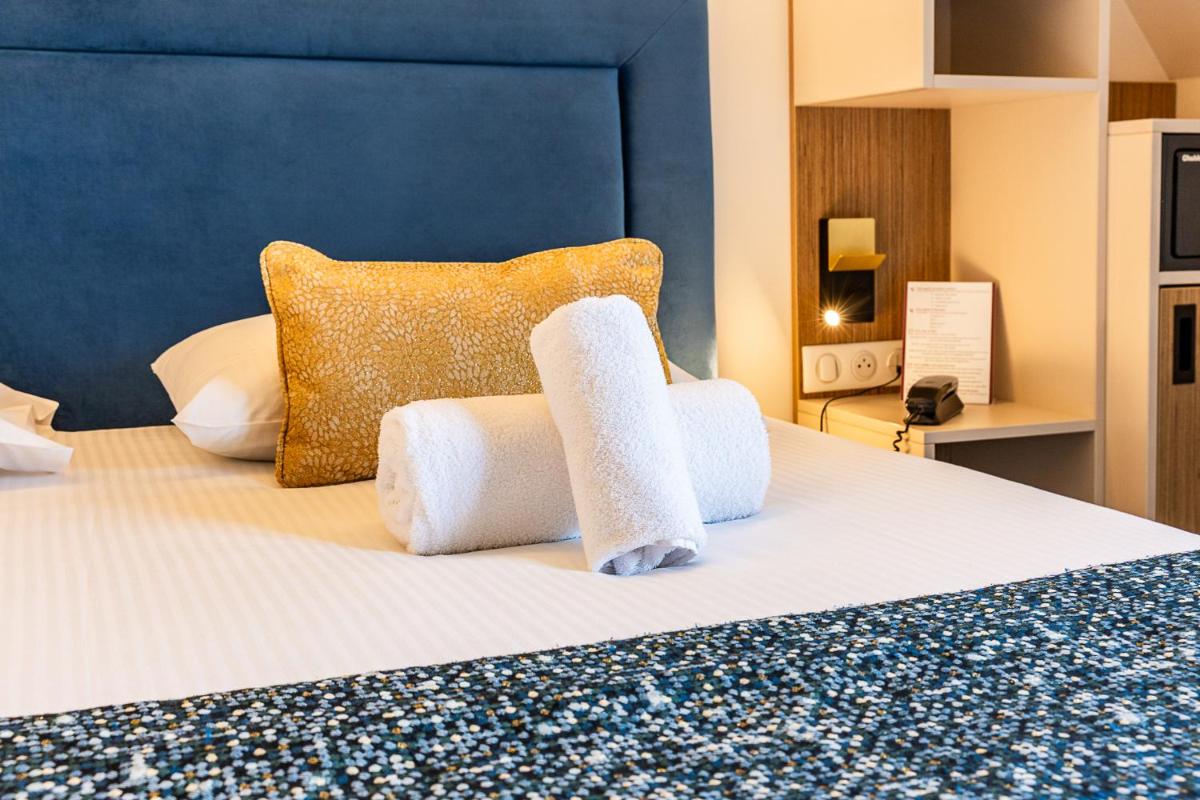 Un ou plusieurs lits dans un hébergement de l'établissement Brit Hotel, Spa & Restaurant - Colmar Est