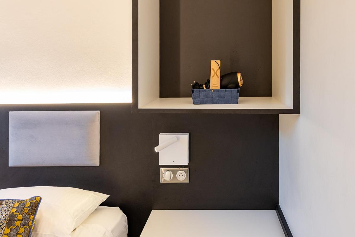 Un ou plusieurs lits dans un hébergement de l'établissement Brit Hotel, Spa & Restaurant - Colmar Est
