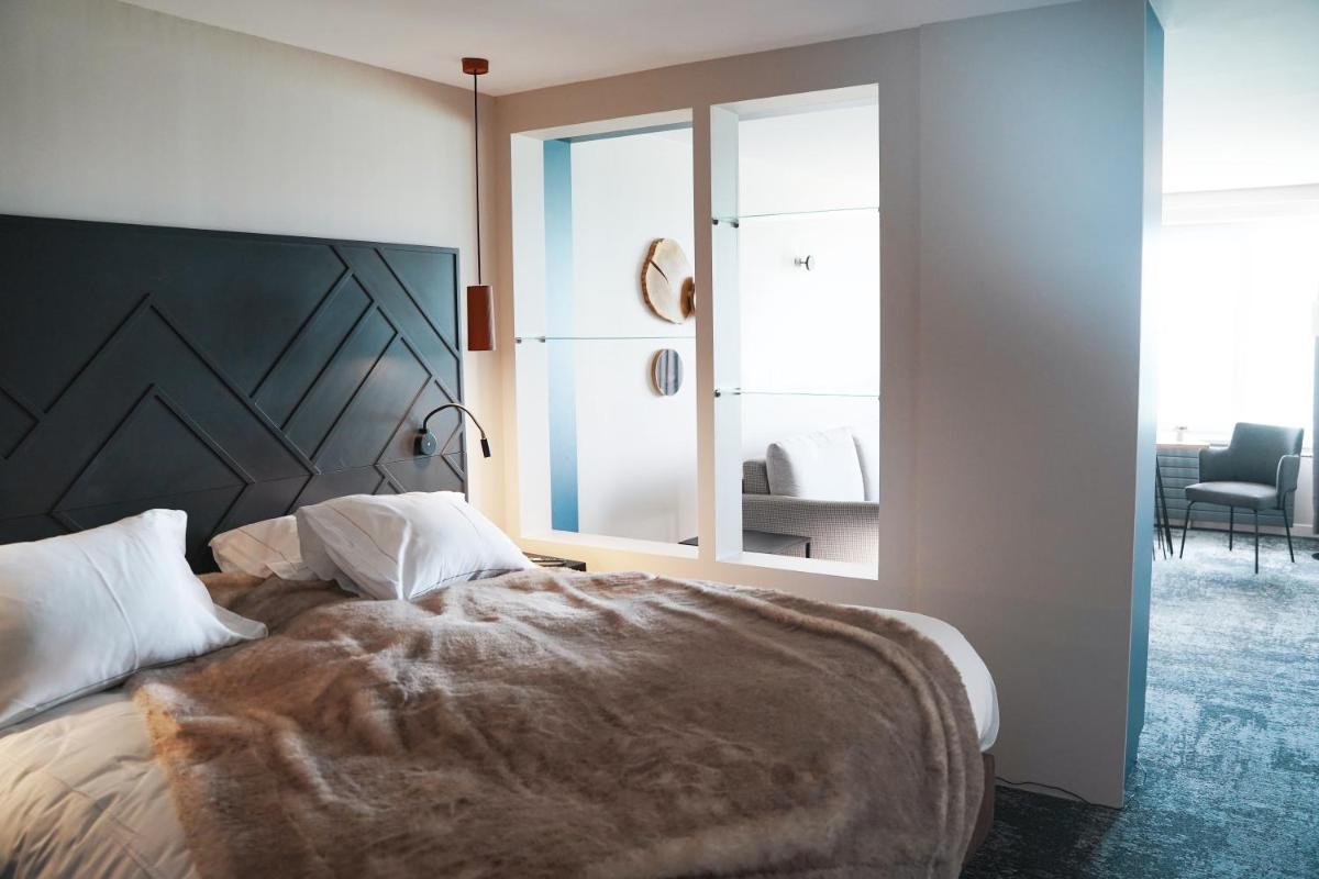 Un ou plusieurs lits dans un hébergement de l'établissement Hotel Atlantic