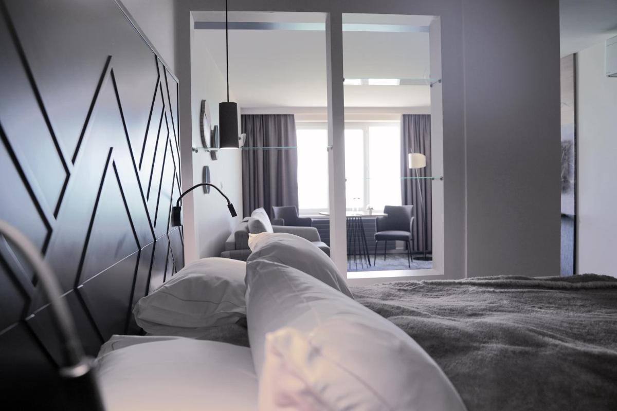 Un ou plusieurs lits dans un hébergement de l'établissement Hotel Atlantic