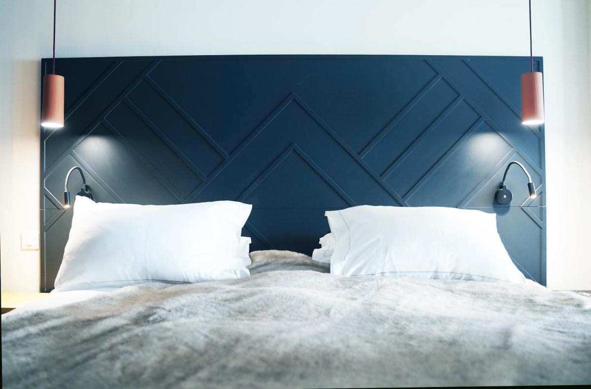 Un ou plusieurs lits dans un hébergement de l'établissement Hotel Atlantic