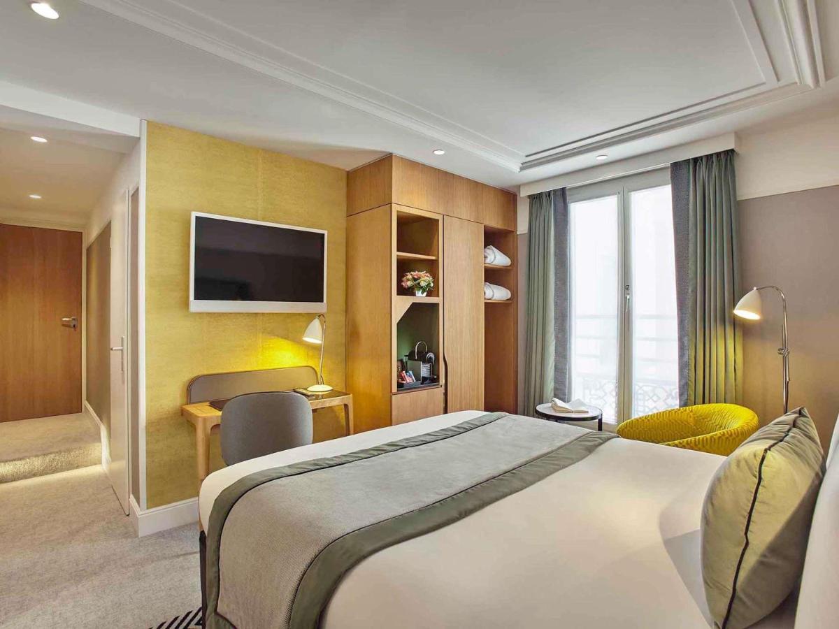 Un ou plusieurs lits dans un hébergement de l'établissement Mercure Paris Opera Garnier Hôtel & Spa