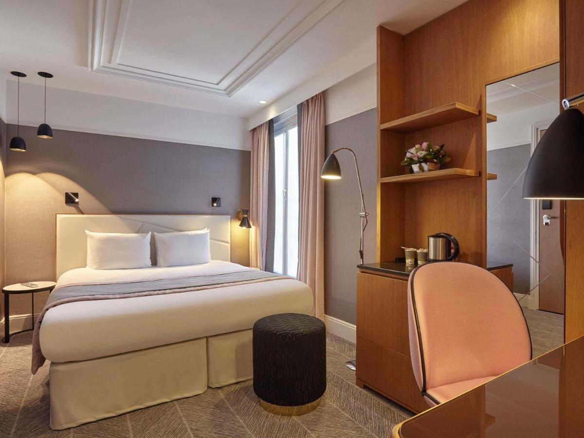 Un ou plusieurs lits dans un hébergement de l'établissement Mercure Paris Opera Garnier Hôtel & Spa
