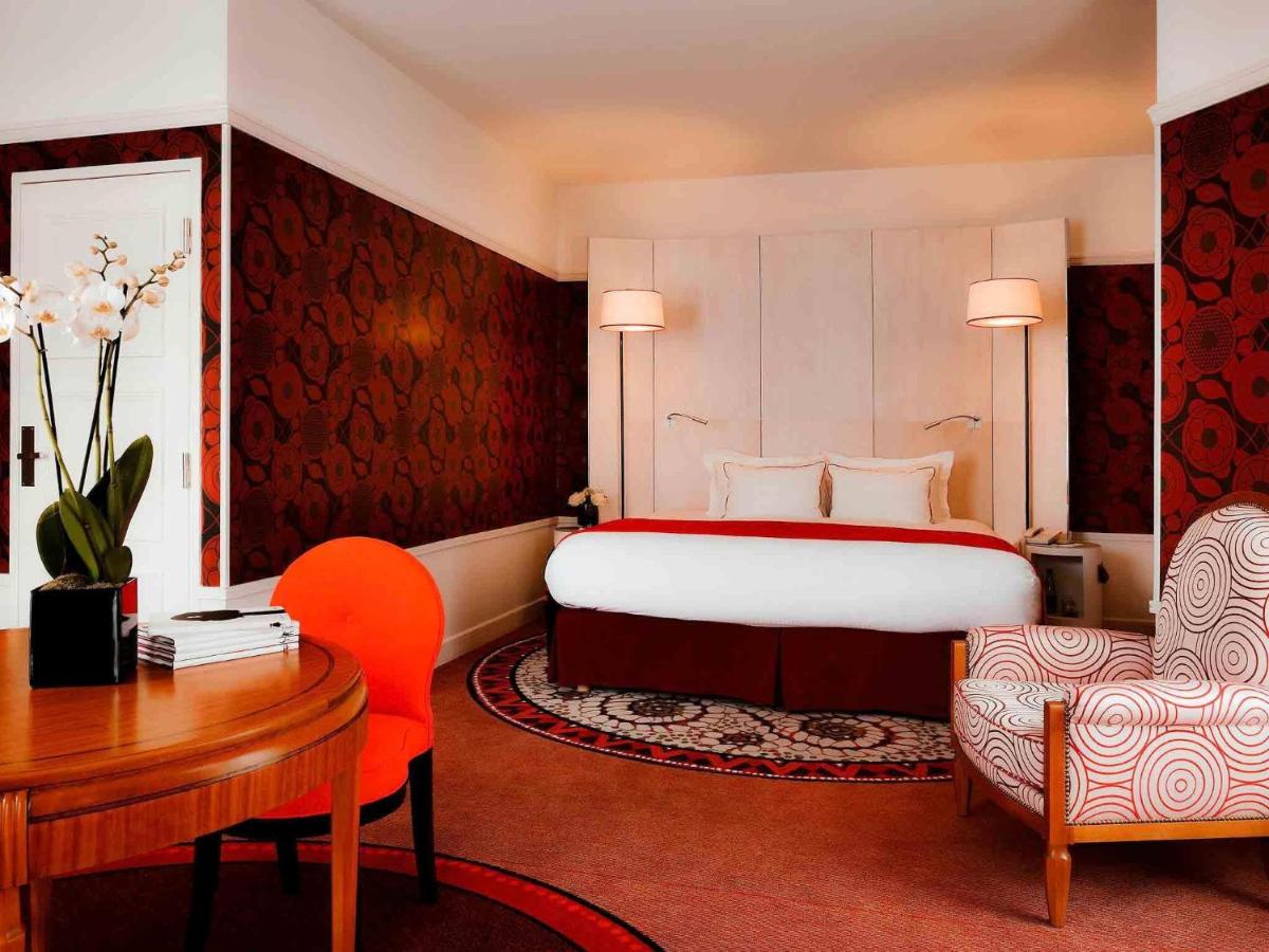 Un ou plusieurs lits dans un hébergement de l'établissement Carlton Hotel Lyon - MGallery Collection