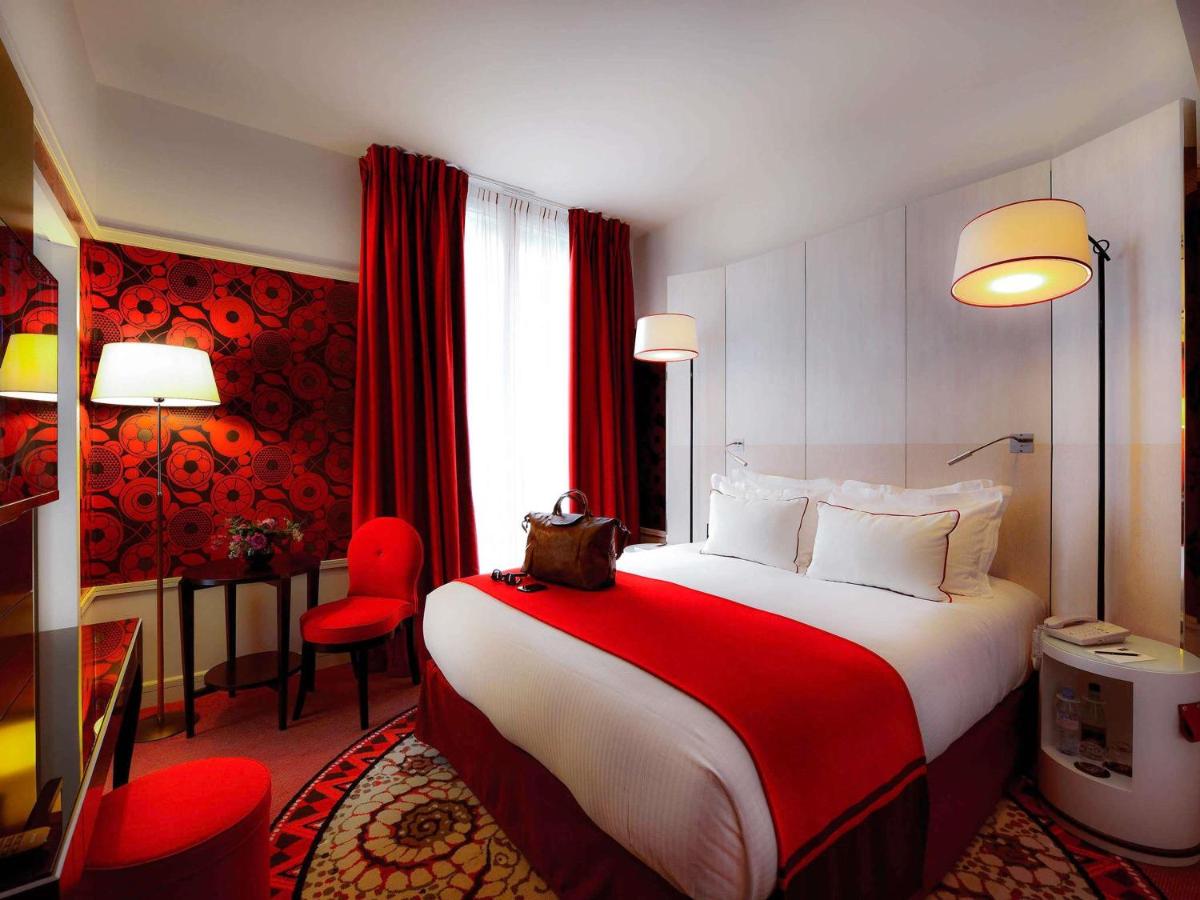 Un ou plusieurs lits dans un hébergement de l'établissement Carlton Hotel Lyon - MGallery Collection