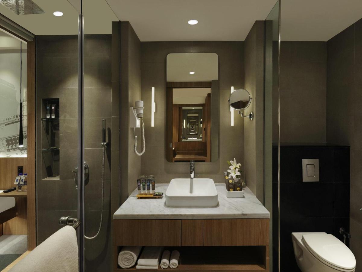 a bathroom with a sink and a shower at Novotel Mumbai Juhu Beach in Mumbai