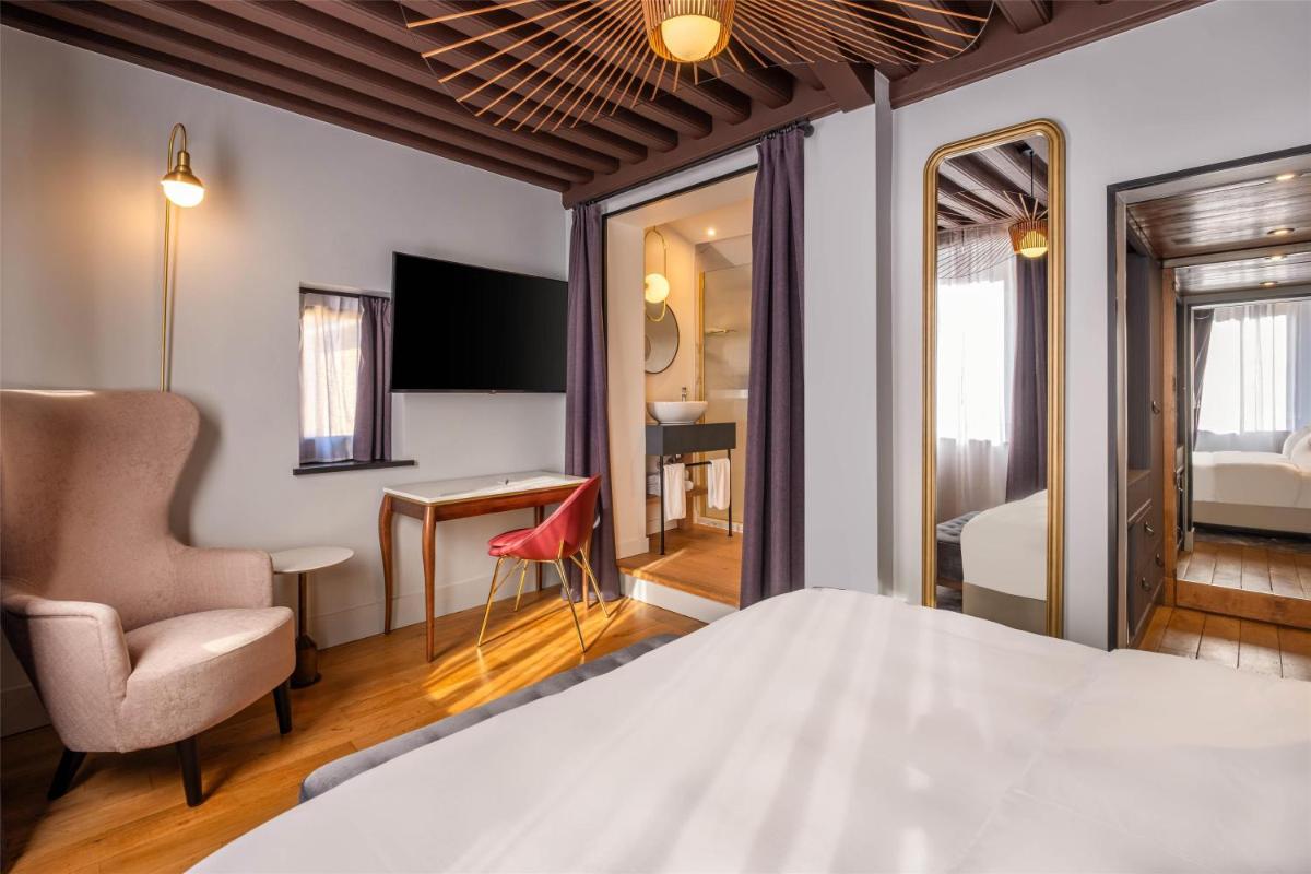 Un ou plusieurs lits dans un hébergement de l'établissement Cour des Loges Lyon, A Radisson Collection Hotel
