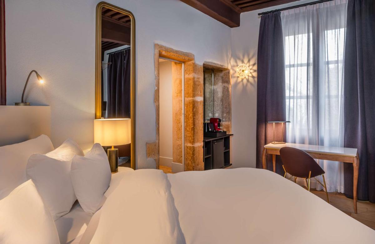 Un ou plusieurs lits dans un hébergement de l'établissement Cour des Loges Lyon, A Radisson Collection Hotel