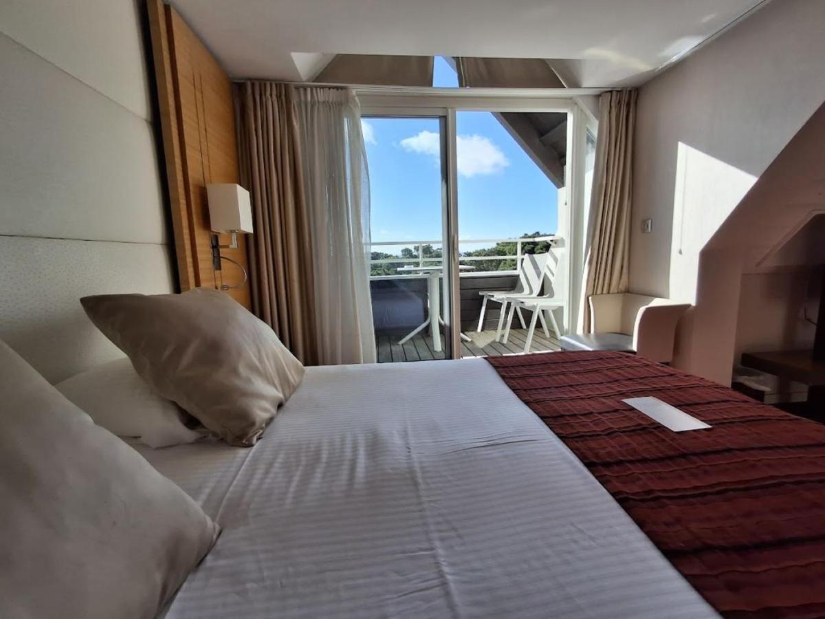Un ou plusieurs lits dans un hébergement de l'établissement Le Churchill Hôtel & Spa