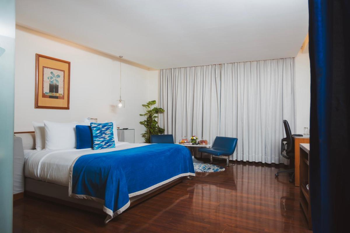 a hotel room with a bed and a desk at The Park New Delhi in New Delhi