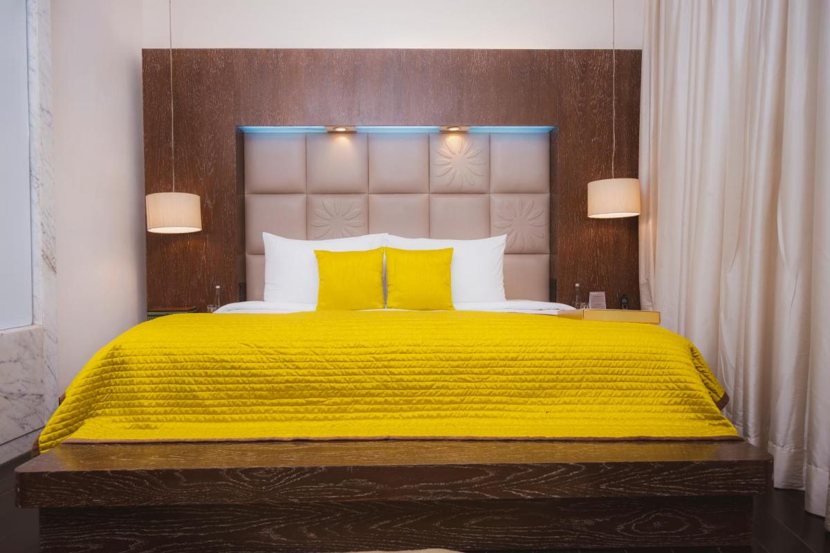 a bedroom with a yellow bed with two yellow pillows at The Park New Delhi in New Delhi