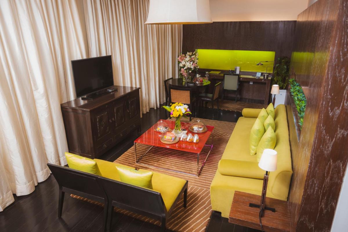 a living room with a yellow couch and a table at The Park New Delhi in New Delhi