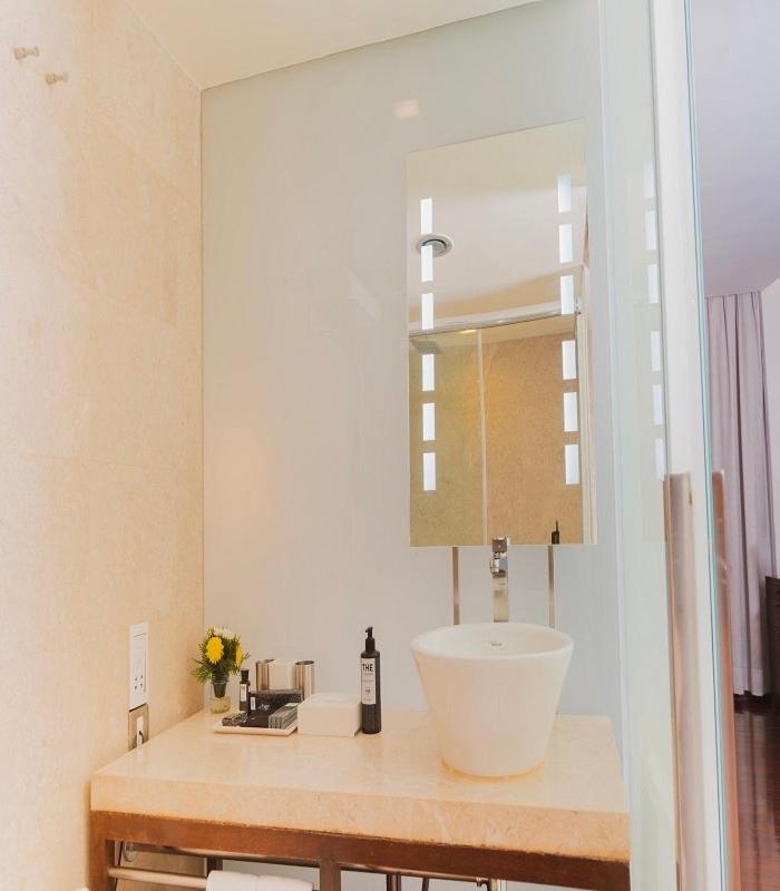 a bathroom with a sink and a mirror at The Park New Delhi in New Delhi