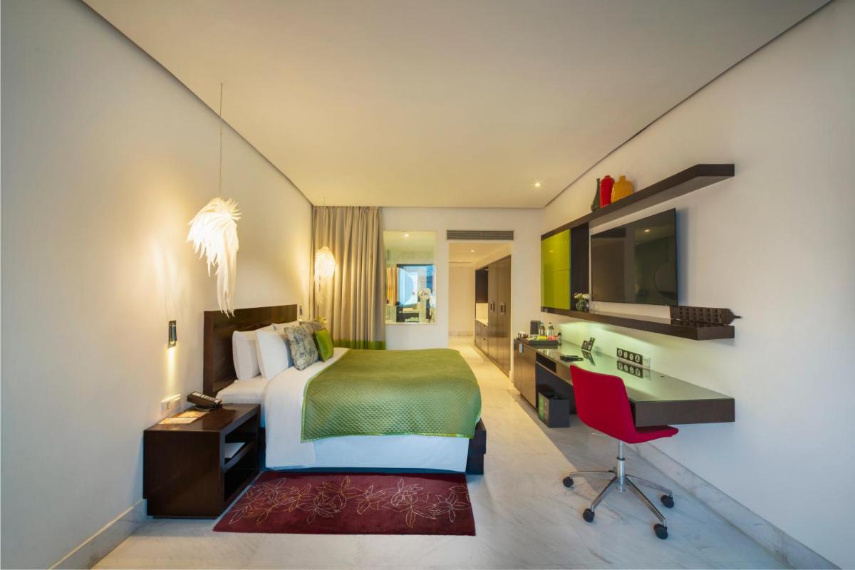 a hotel room with a bed and a desk at The Park Chennai in Chennai