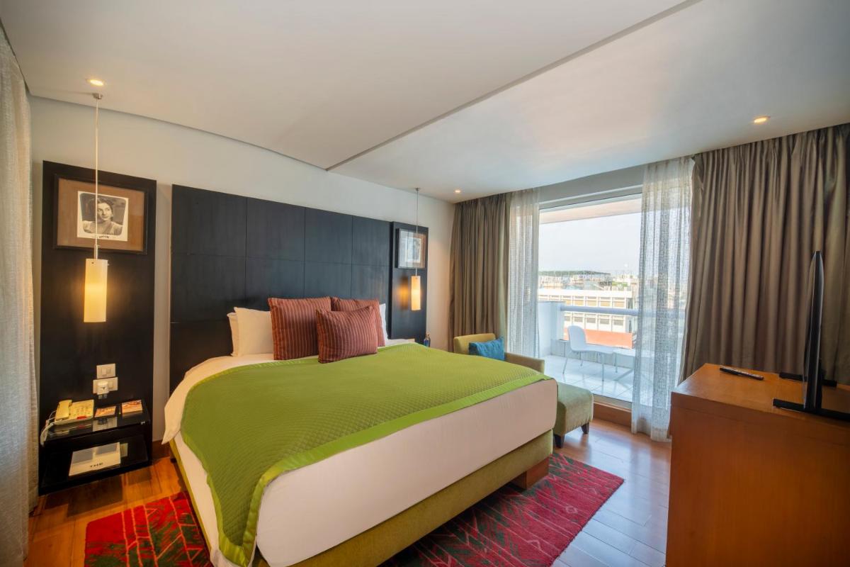 a bedroom with a large bed and a large window at The Park Chennai in Chennai