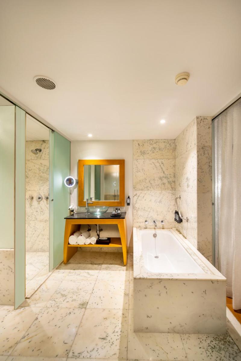 a bathroom with a tub and a sink at The Park Chennai in Chennai