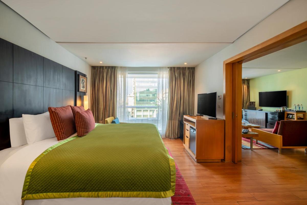 a hotel room with a bed and a television at The Park Chennai in Chennai