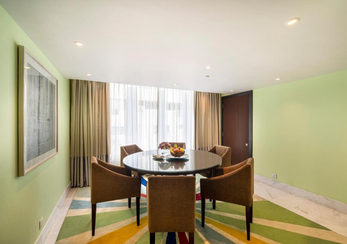 a dining room with a table and chairs at The Park Chennai in Chennai