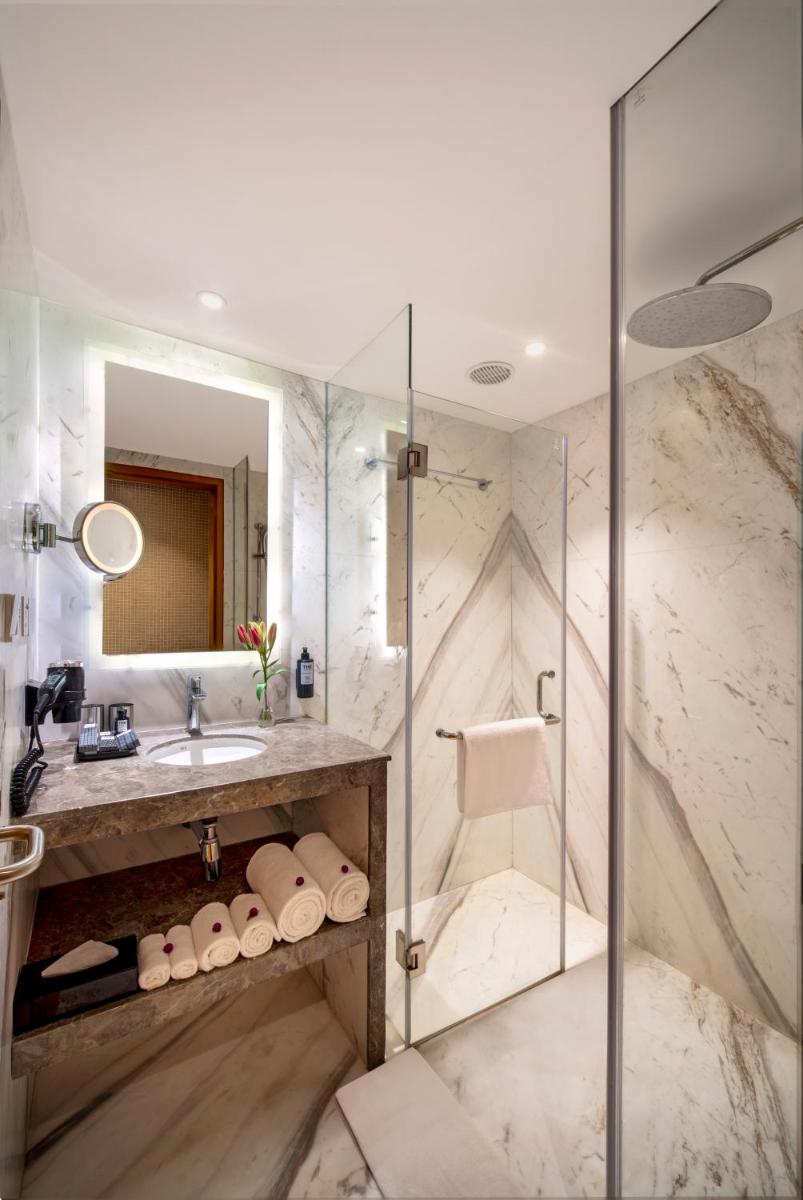 a bathroom with a shower and a sink at The Park Chennai in Chennai