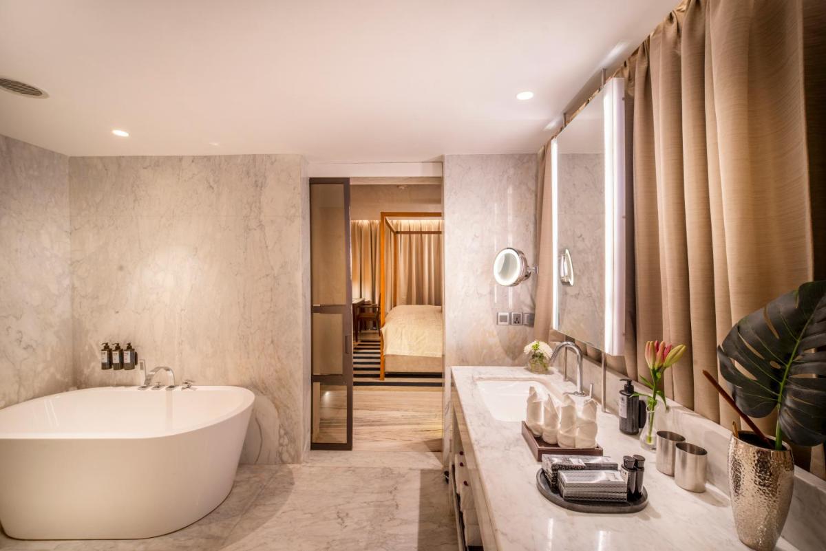 a bathroom with a large tub and a sink at The Park Chennai in Chennai