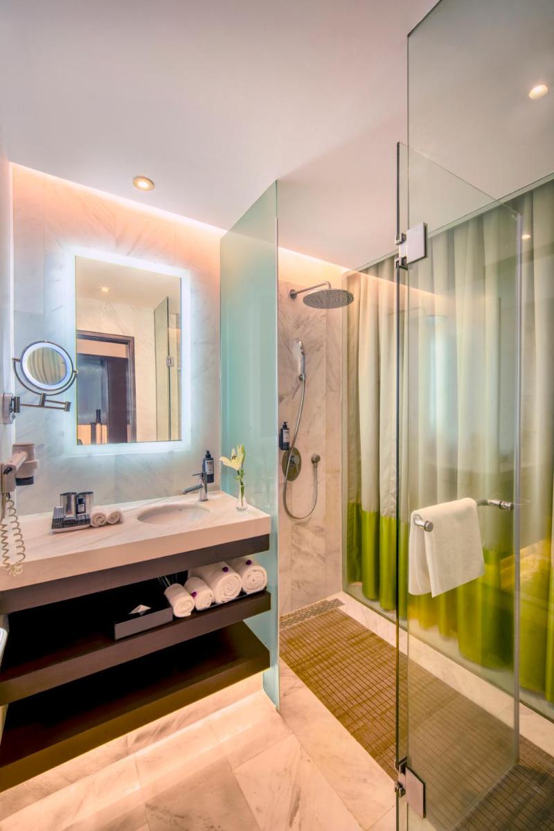 a bathroom with a sink and a shower at The Park Chennai in Chennai