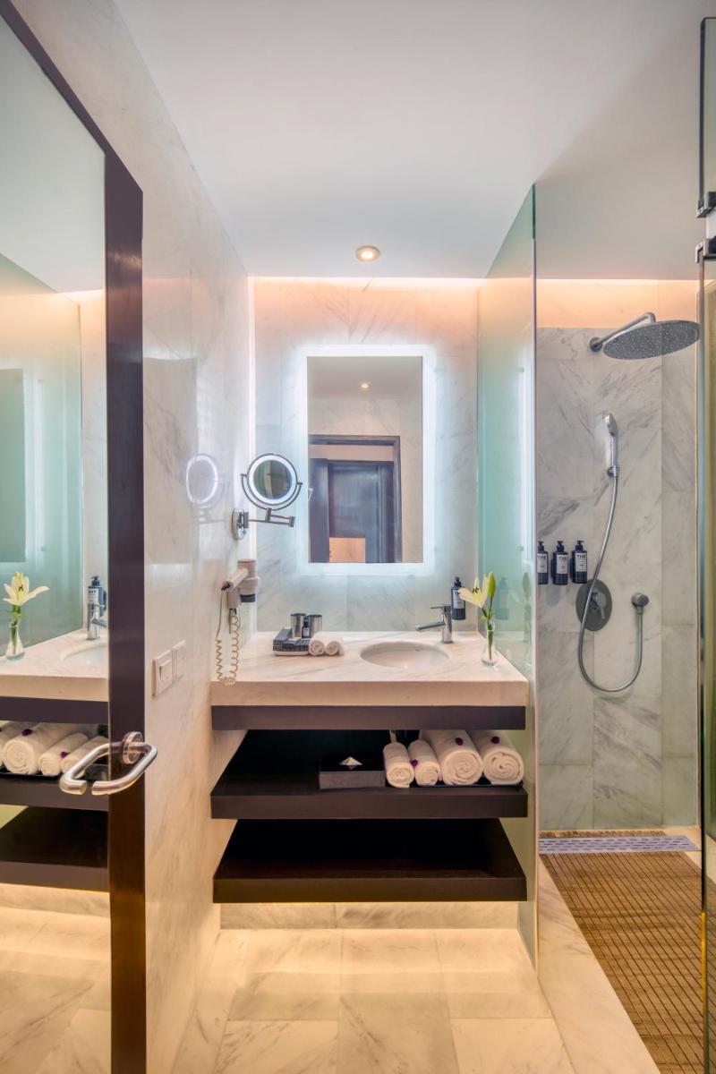 a bathroom with a sink and a shower at The Park Chennai in Chennai