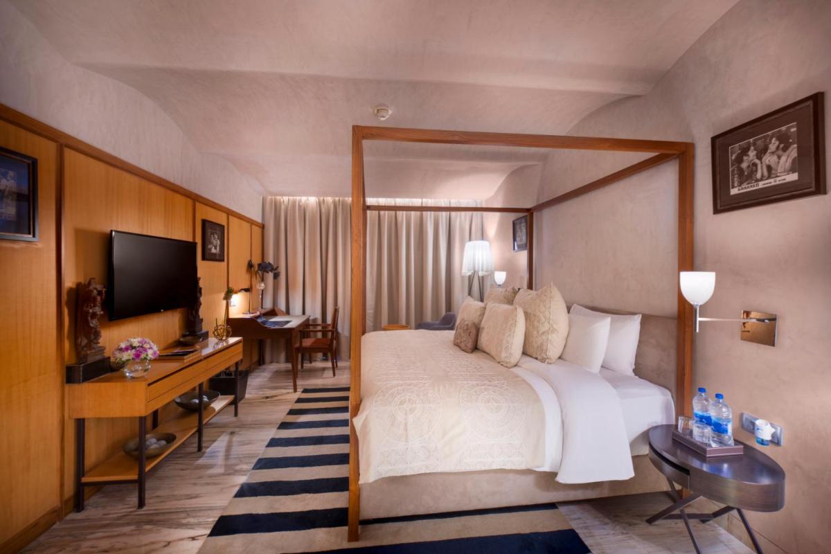 a hotel room with a bed and a desk and a television at The Park Chennai in Chennai