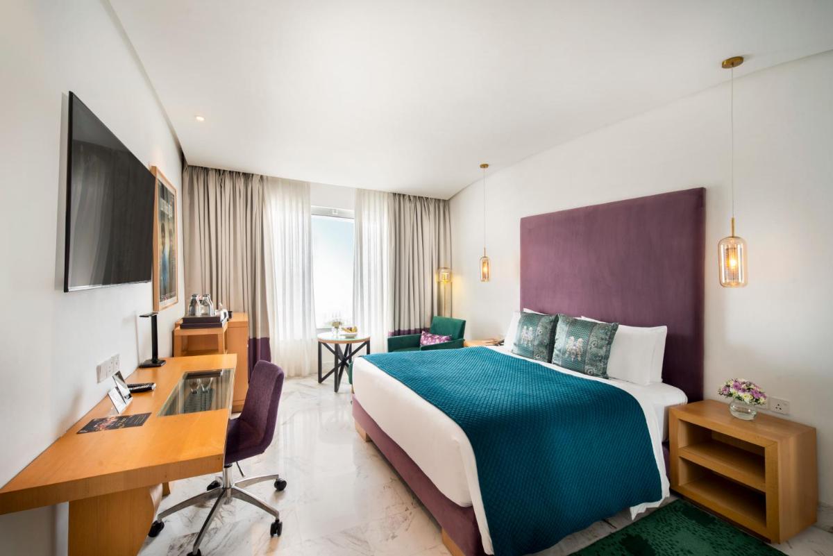 a hotel room with a bed and a desk at The Park Chennai in Chennai