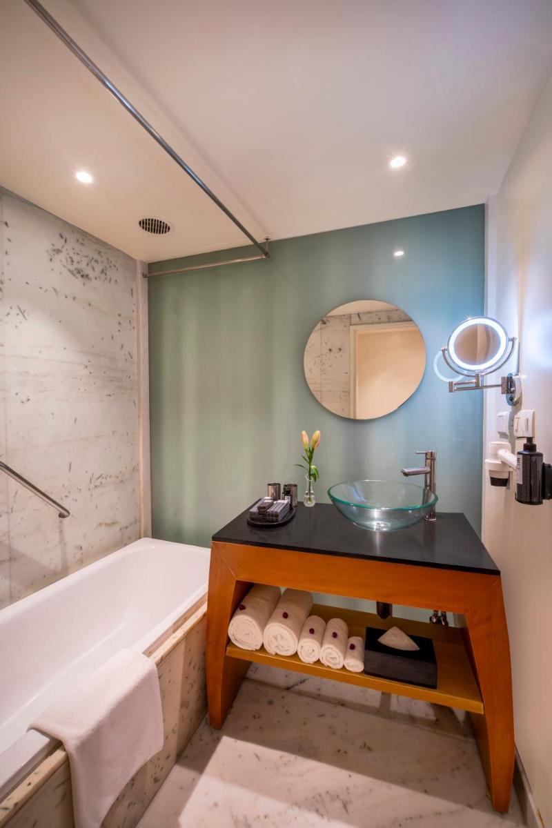 a bathroom with a tub and a sink at The Park Chennai in Chennai