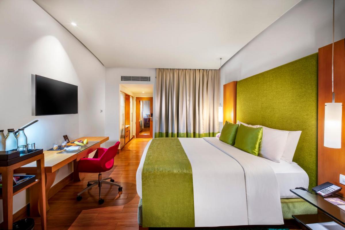 a hotel room with a bed and a desk at The Park Chennai in Chennai
