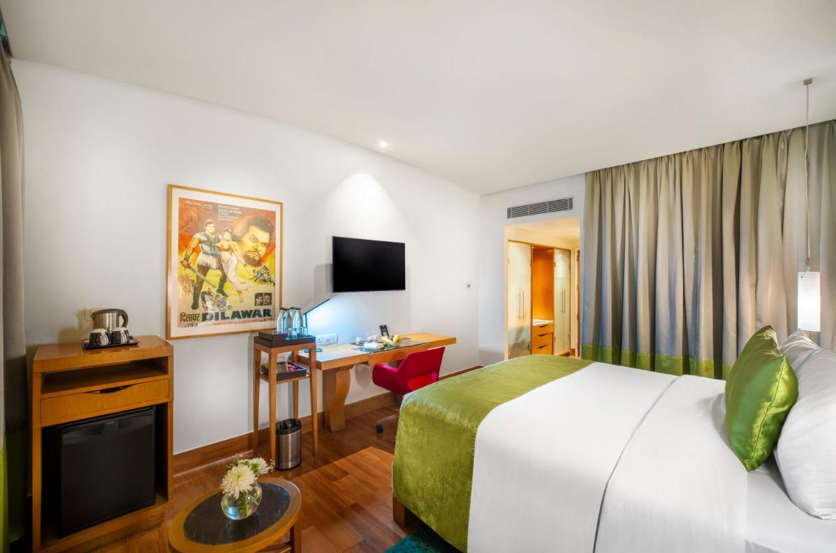 a hotel room with a bed and a desk at The Park Chennai in Chennai