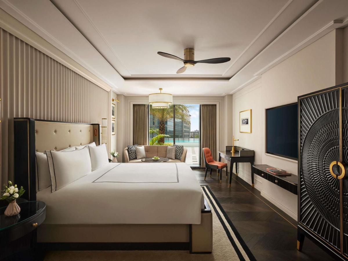 a hotel room with a bed and a desk at Fairmont Mumbai in Mumbai