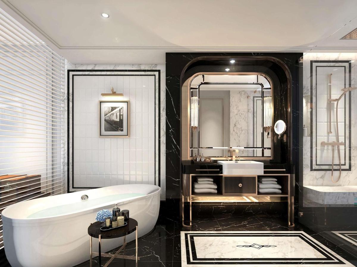 a bathroom with a bath tub and a sink at Fairmont Mumbai in Mumbai