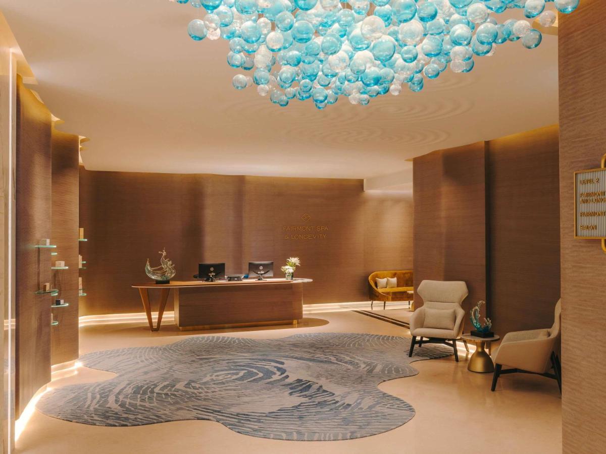 a lobby with a large chandelier in a hotel at Fairmont Mumbai in Mumbai
