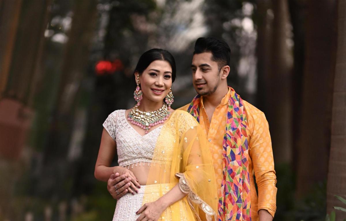 a bride and groom pose for a picture at their wedding at Radisson Blu Hotel Pune Kharadi in Pune
