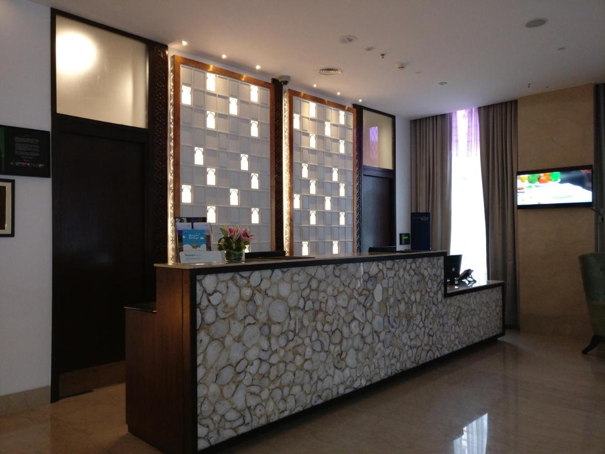 a lobby of a hotel with a reception desk at Mercure Hyderabad KCP Banjara Hills, An Accor Hotel in Hyderabad