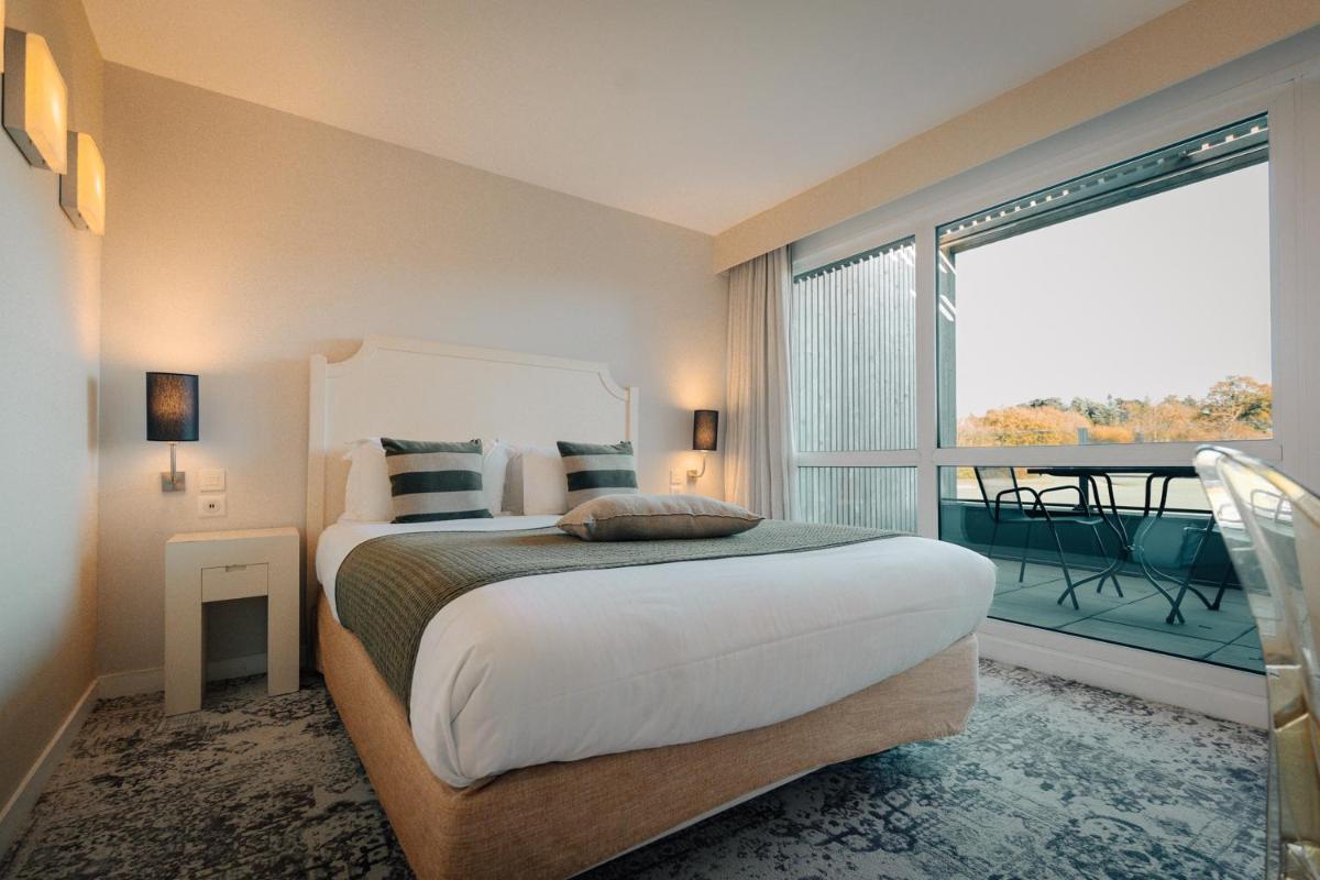 Un ou plusieurs lits dans un hébergement de l'établissement Best Western Plus Le Roi Arthur Hôtel & Spa
