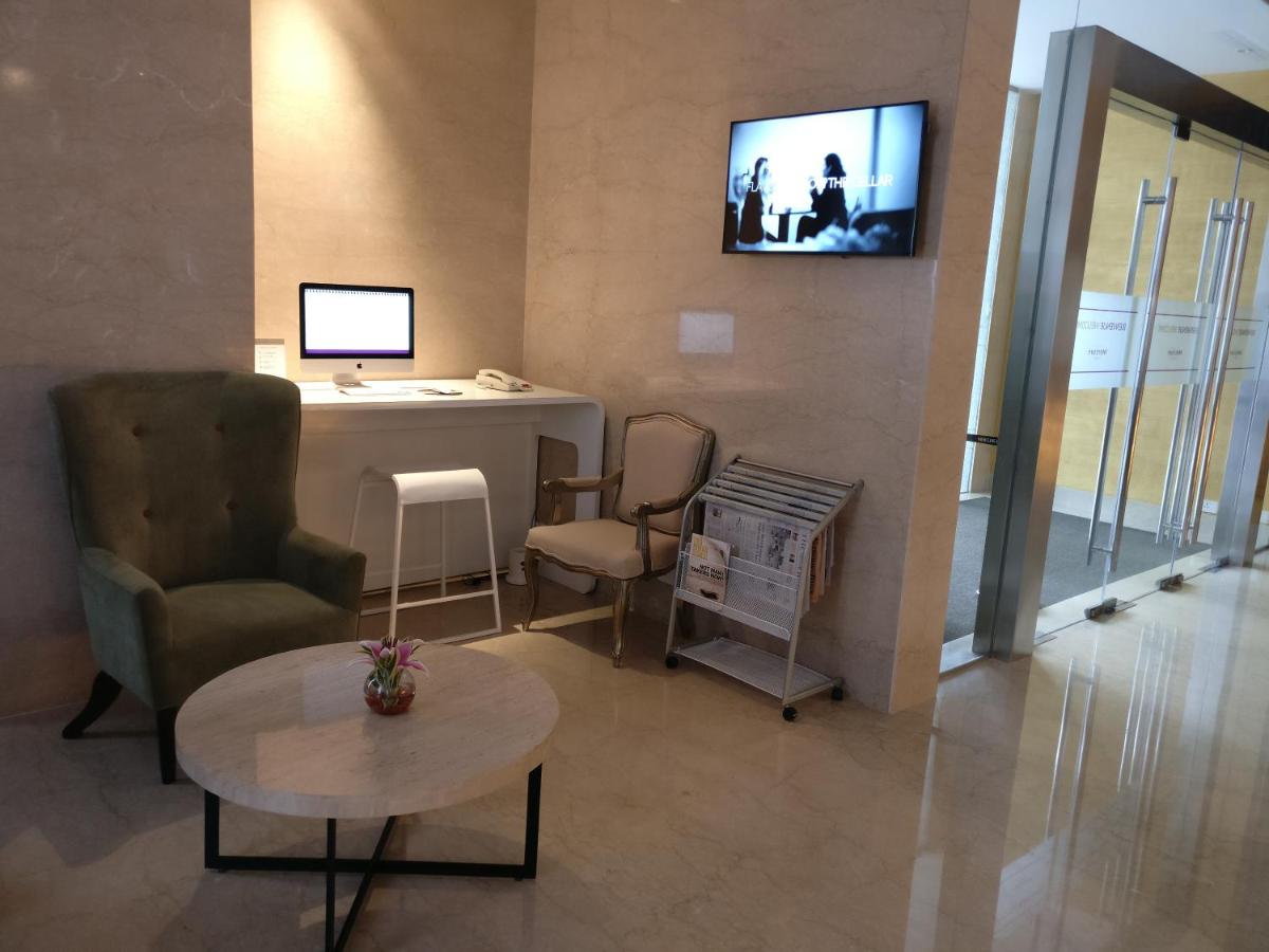 a living room with a tv on a wall at Mercure Hyderabad KCP Banjara Hills, An Accor Hotel in Hyderabad