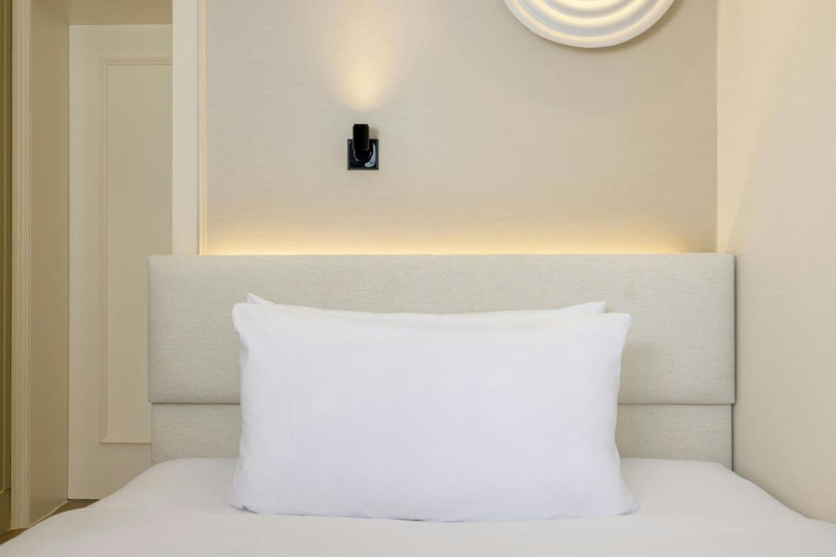 Ein Bett oder Betten in einem Zimmer der Unterkunft Le Méridien Frankfurt