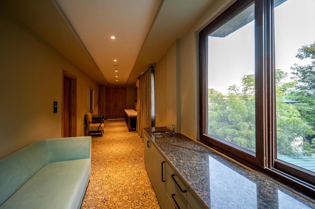 a hospital room with a large window and a corridor at Essentia Luxury Resort & Spa Udaipur in Udaipur