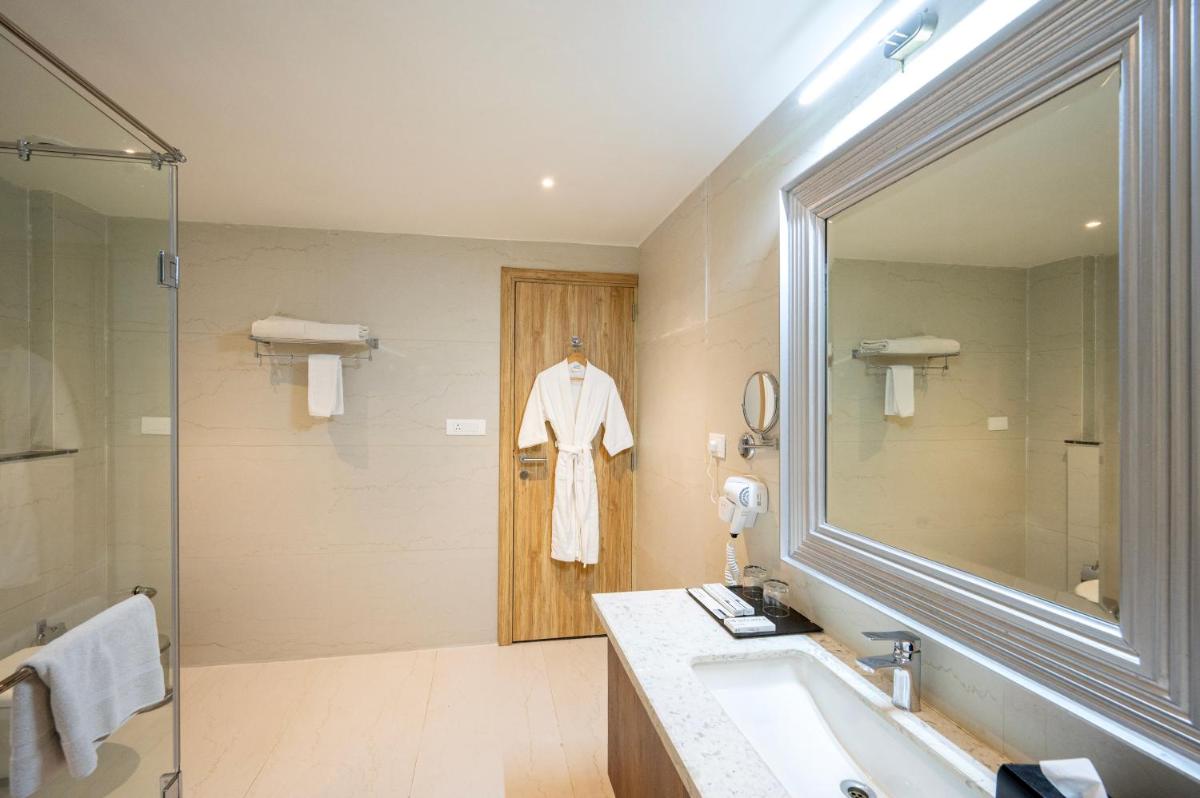 a bathroom with a sink and a mirror at Essentia Luxury Resort & Spa Udaipur in Udaipur