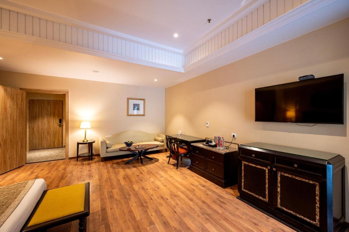 a living room with a flat screen tv on the wall at Essentia Luxury Resort & Spa Udaipur in Udaipur