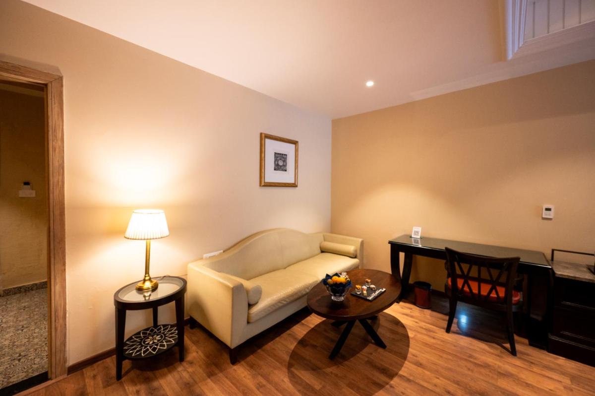 a living room with a couch and a table at Essentia Luxury Resort & Spa Udaipur in Udaipur