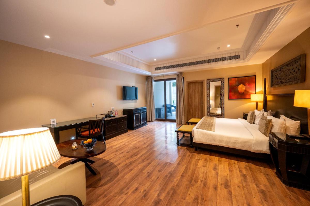 a hotel room with a bed and a desk at Essentia Luxury Resort & Spa Udaipur in Udaipur