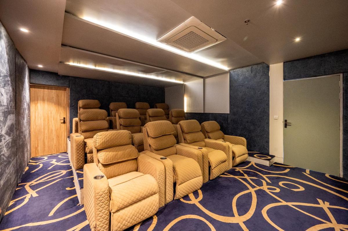 a conference room with chairs and a screen at Essentia Luxury Resort & Spa Udaipur in Udaipur