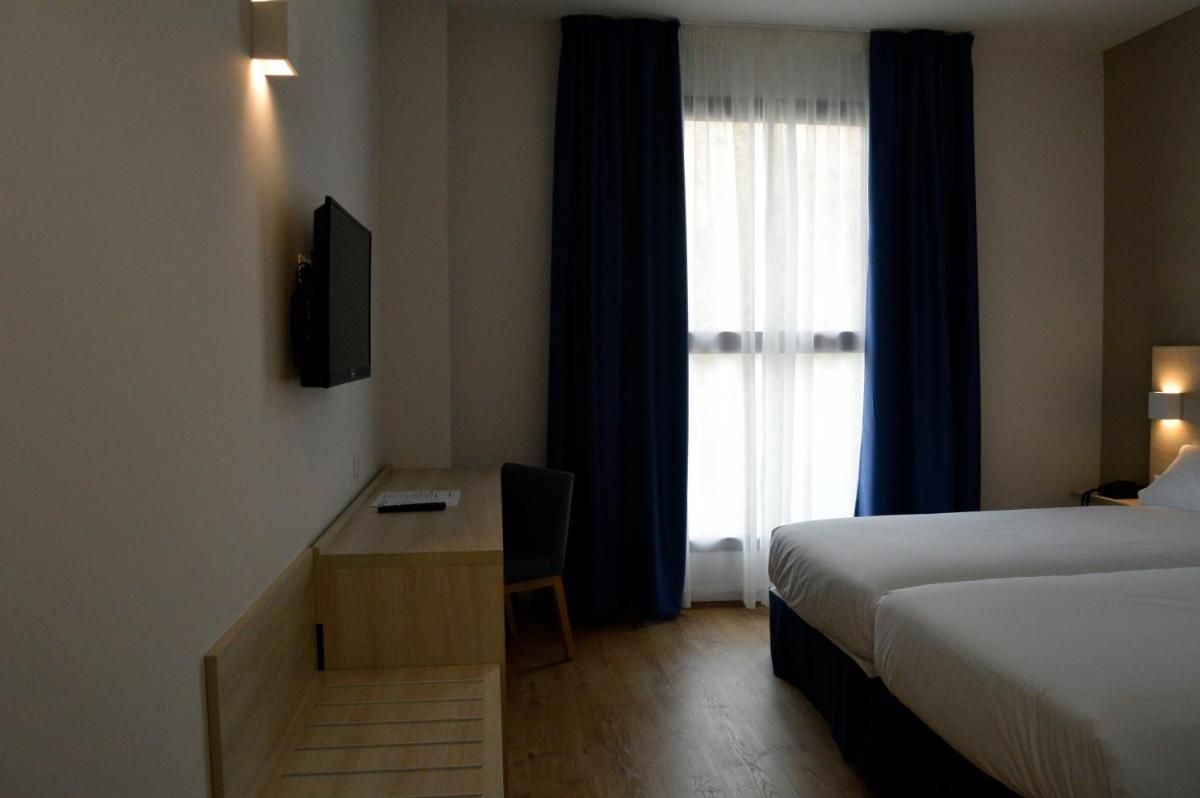 Cama o camas de una habitación en Hotel Balneario de Graena