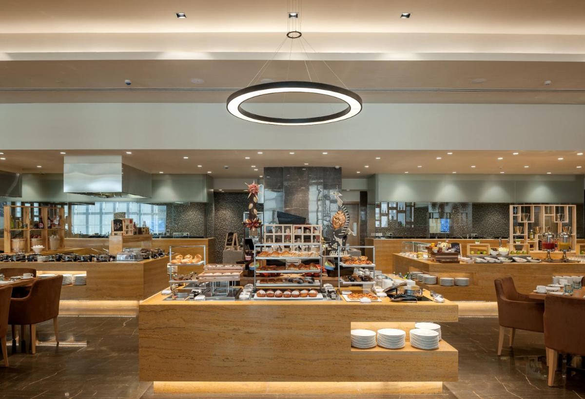 a restaurant with a buffet of food on display at Feathers- A Radha Hotel, Chennai in Chennai