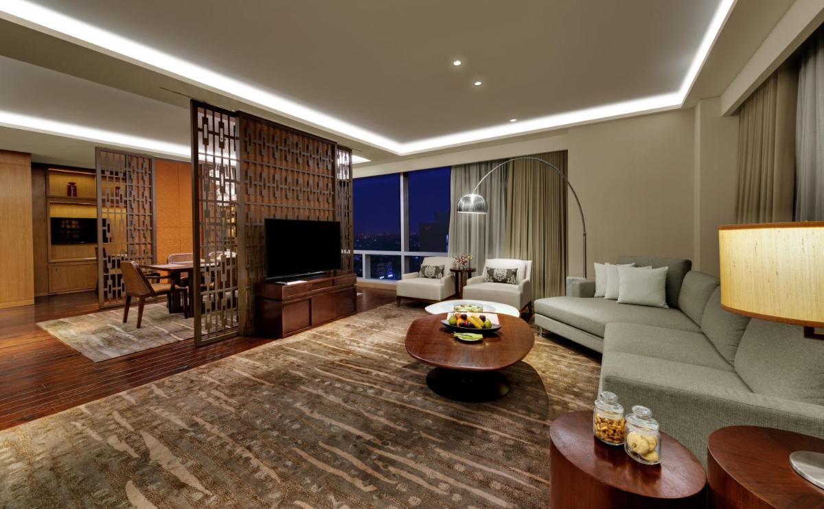 a living room with a couch and a table at Hyatt Regency Ahmedabad in Ahmedabad