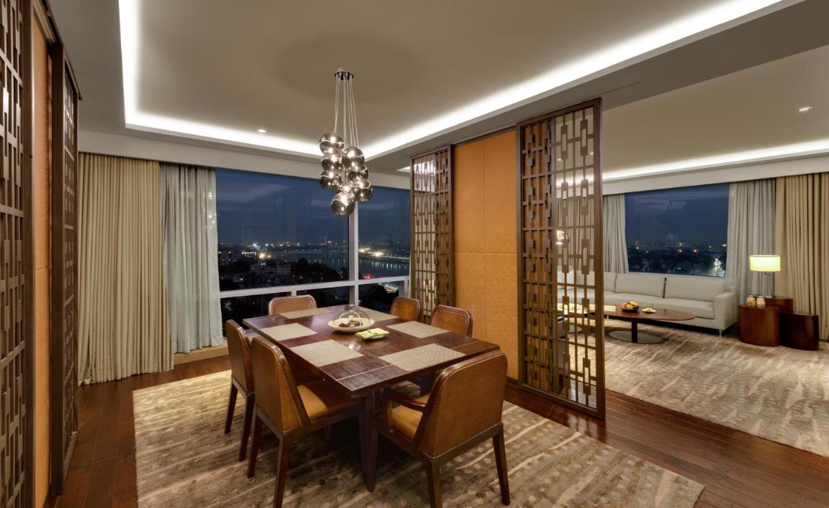 a dining room with a table and a large window at Hyatt Regency Ahmedabad in Ahmedabad