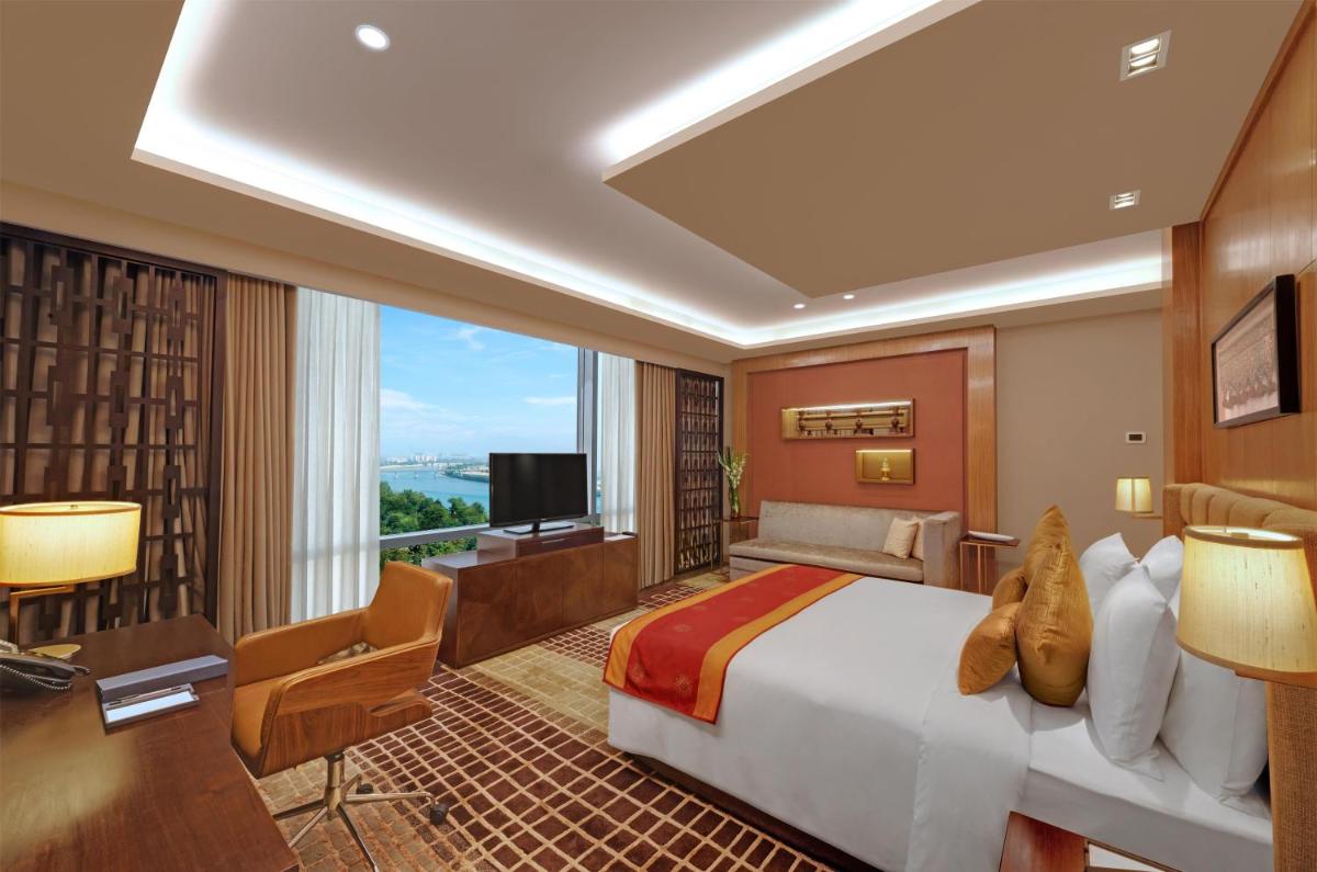 a hotel room with a bed and a television at Hyatt Regency Ahmedabad in Ahmedabad